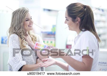 Young woman talking to pharmacist View Large Photo Image Stock Photo - Young woman talking to pharmacist. Fotosearch