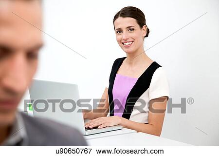 Stock Photo - Young woman using laptop. Fotosearch