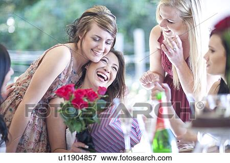 Young woman with friends and birthday presents View Large Photo Image Stock Photo - Young woman with friends and birthday presents. Fotosearch