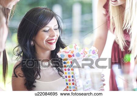 Young woman with friends and birthday present View Large Photo Image Stock Photography - Young woman with friends and birthday present. Fotosearch