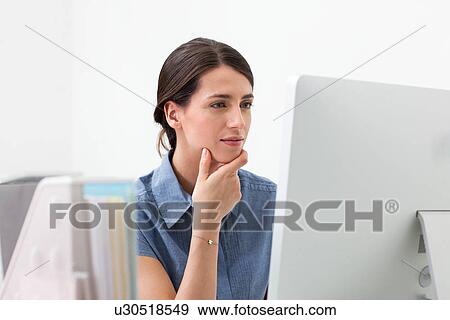 Young woman working on computer View Large Photo Image Stock Photo - Young woman working on computer. Fotosearch