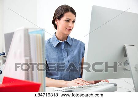 Young woman working on computer View Large Photo Image Stock Photo - Young woman working on computer. Fotosearch