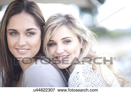Young women hugging View Large Photo Image Stock Photo - Young women hugging. Fotosearch