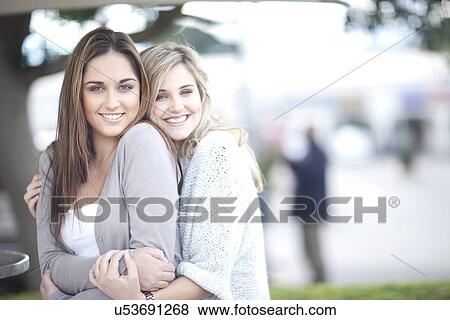 Young women hugging View Large Photo Image Stock Photo - Young women hugging. Fotosearch