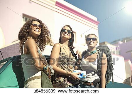 Young women leaning against car View Large Photo Image Stock Photo - Young women leaning against car. Fotosearch