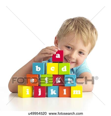 Stock Image - Boy playing with alphabet blocks. Fotosearch