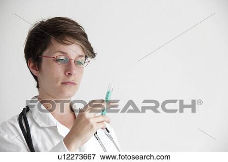 Stock Photo - Doctor with syringe. Fotosearch