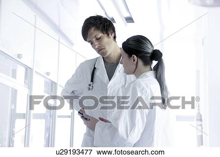 Stock Photo - Doctors discussing notes. Fotosearch