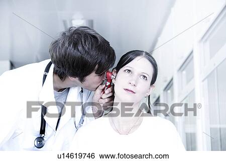 Ear examination View Large Photo Image Stock Photograph - Ear examination. Fotosearch