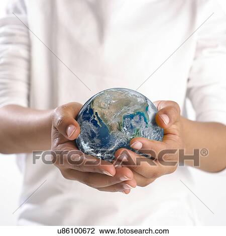 Stock Image - Earth held in child's hands. Fotosearch