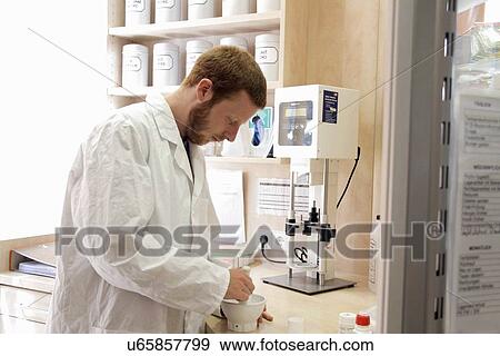 Stock Photo - Pharmacist preparing drugs. Fotosearch
