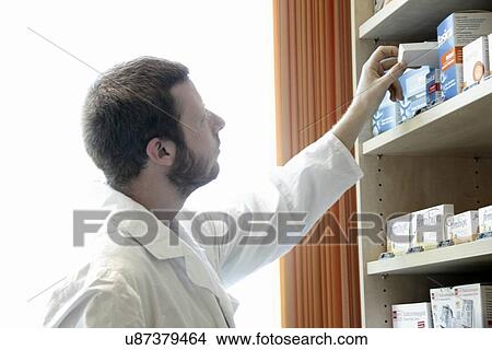 Pharmacist selecting drugs View Large Photo Image Picture - Pharmacist selecting drugs. Fotosearch