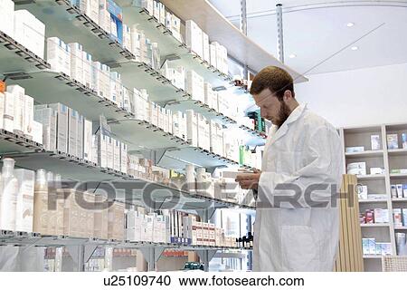 Pharmacist selecting drugs View Large Photo Image Stock Image - Pharmacist selecting drugs. Fotosearch