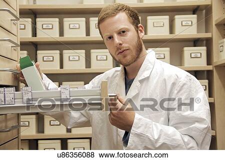 Stock Photo - Pharmacist selecting drugs. Fotosearch