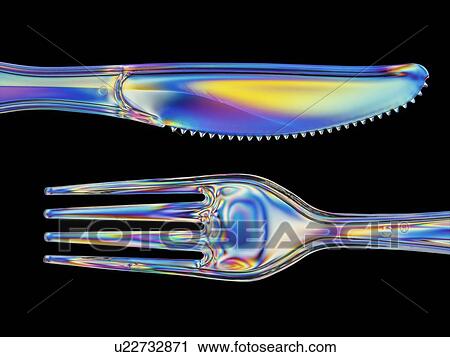 Stock Image - Photoelastic stress of a knife and fork. Fotosearch