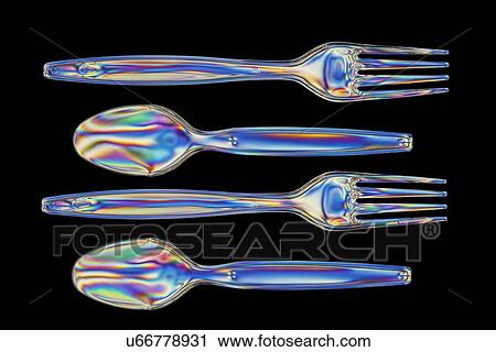 Stock Image - Photoelastic stress of forks and spoons. Fotosearch