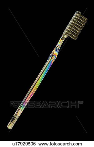 Photoelastic stress of toothbrush View Large Photo Image Stock Photograph - Photoelastic stress of toothbrush. Fotosearch