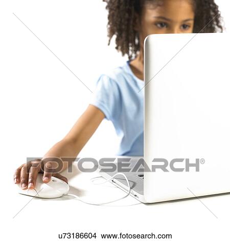 Picture - Young girl using a laptop. Fotosearch