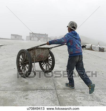 Boy pushing handcart on a street, Nagarze, Shannan, Tibet, China View Large Photo Image Stock Image - Boy pushing handcart on a street, Nagarze, Shannan, Tibet, China. Fotosearch