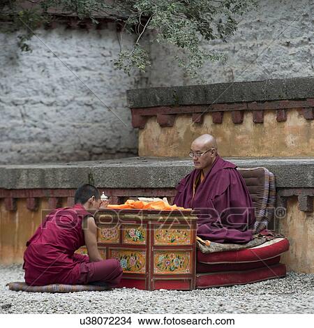 Picture - Buddhist monk reciting teachings of Buddha to his pupil in Sera Monastery, Lhasa, Tibet, China. Fotosearch