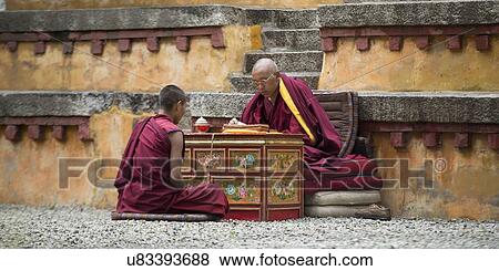 Stock Photo - Buddhist monk reciting teachings of Buddha to his pupil in Sera Monastery, Lhasa, Tibet, China. Fotosearch