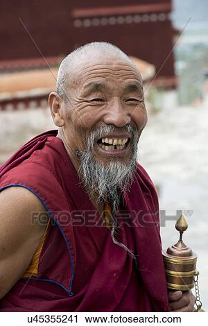 Buddhist monk with prayer wheel in Drepung Monastery, Lhasa, Tibet, China View Large Photo Image Stock Image - Buddhist monk with prayer wheel in Drepung Monastery, Lhasa, Tibet, China. Fotosearch
