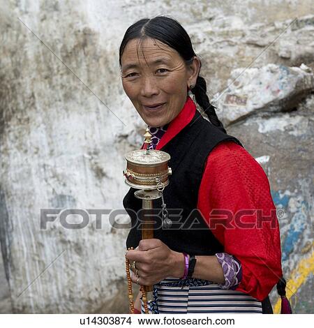 Buddhist woman with prayer wheel in Drepung Monastery, Lhasa, Tibet, China View Large Photo Image Picture - Buddhist woman with prayer wheel in Drepung Monastery, Lhasa, Tibet, China. Fotosearch
