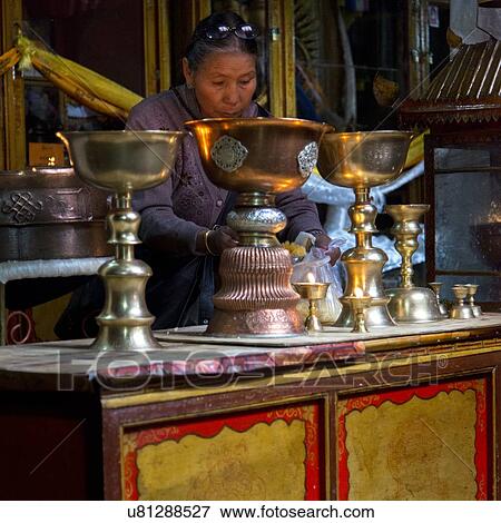 Stock Photo - Buddhist woman with religious offerings in Ani Tsangkung Nunnery, Barkhor, Lhasa, Tibet, China. Fotosearch