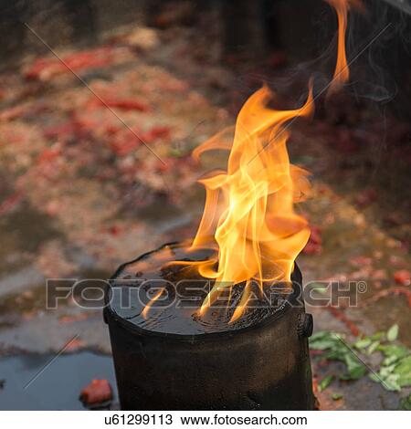 Stock Image - Burning oil lamp at a temple, Xian, Shaanxi, China.. Fotosearch