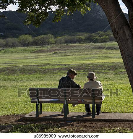 Couple sitting on the bench, Diamond Head, Kapahulu, St. Louis, Honolulu, Oahu, Hawaii, USA View Large Photo Image Stock Photo - Couple sitting on the bench, Diamond Head, Kapahulu, St. Louis, Honolulu, Oahu, Hawaii, USA. Fotosearch