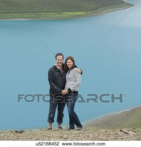 Couple standing at Yamdrok Lake, Nagarze, Shannan, Tibet, China View Large Photo Image Stock Image - Couple standing at Yamdrok Lake, Nagarze, Shannan, Tibet, China. Fotosearch