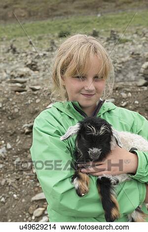 Picture - Girl holding a lamb, Nagarze, Shannan, Tibet, China. Fotosearch