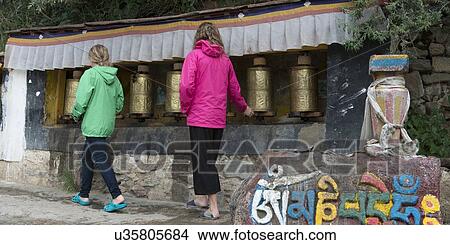 Girls spinning prayer wheels at Drepung Monastery, Lhasa, Tibet, China View Large Photo Image Picture - Girls spinning prayer wheels at Drepung Monastery, Lhasa, Tibet, China. Fotosearch