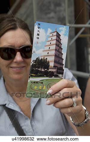 Happy woman showing entry ticket to Giant Wild Goose Pagoda, Xi'an, Shaanxi, China. View Large Photo Image Stock Image - Happy woman showing entry ticket to Giant Wild Goose Pagoda, Xi'an, Shaanxi, China.. Fotosearch
