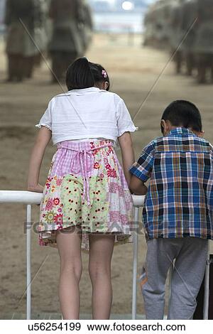 Kids looking down with curiosity at Terracotta Warriors Army Museum, Xi'an, Shaanxi, China. View Large Photo Image Stock Photo - Kids looking down with curiosity at Terracotta Warriors Army Museum, Xi'an, Shaanxi, China.. Fotosearch