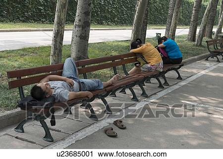 Man and women sleeping on park bench, Xi'an, China. View Large Photo Image Stock Image - Man and women sleeping on park bench, Xi'an, China.. Fotosearch
