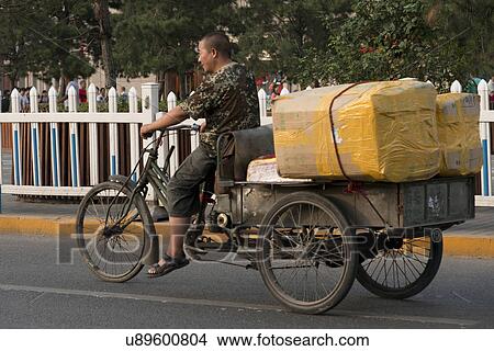 Picture - Man riding bicycle cart, Xi'an, Shaanxi, China.. Fotosearch