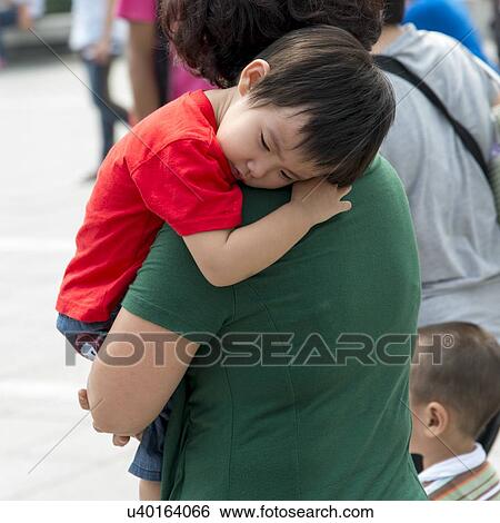 Mother carrying her sleeping son. Xi'an, Shaanxi, China. View Large Photo Image Stock Photograph - Mother carrying her sleeping son. Xi'an, Shaanxi, China.. Fotosearch