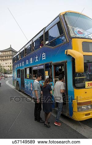 Stock Photo - Passenger boarding the double decker tour bus, Xi'an, Shaanxi, China.. Fotosearch