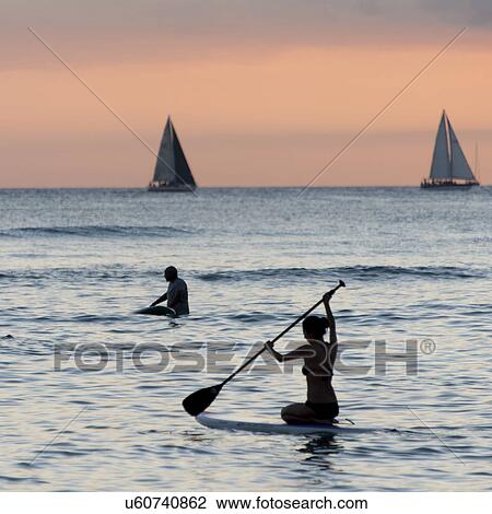 People paddleboarding in the ocean, Waikiki, Honolulu, Oahu, Hawaii, USA View Large Photo Image Stock Image - People paddleboarding in the ocean, Waikiki, Honolulu, Oahu, Hawaii, USA. Fotosearch