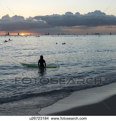 People surfing in the ocean at sunset, Waikiki, Honolulu, Oahu, Hawaii, USA View Large Photo Image Picture - People surfing in the ocean at sunset, Waikiki, Honolulu, Oahu, Hawaii, USA. Fotosearch