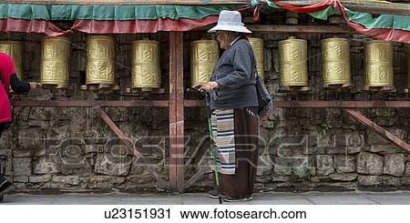 Pilgrim spinning prayer wheels at Potala Palace, Lhasa, Tibet, China View Large Photo Image Stock Image - Pilgrim spinning prayer wheels at Potala Palace, Lhasa, Tibet, China. Fotosearch