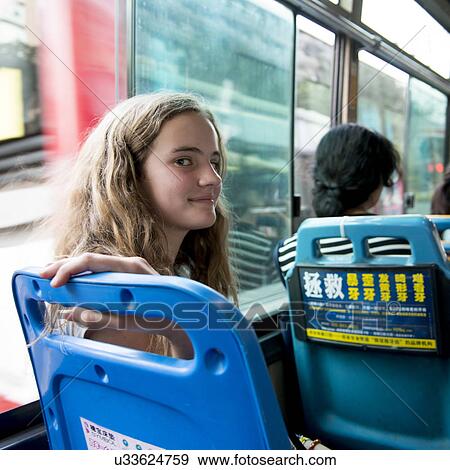 Stock Photo - Portrait of a cute teenage girl smiling in tour bus, Xi'an, Shaanxi, China.. Fotosearch