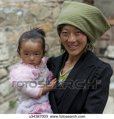 Stock Image - Portrait of a woman with her daughter in Drepung Monastery, Lhasa, Tibet, China. Fotosearch