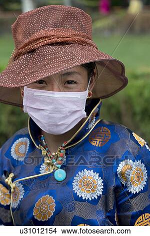 Portrait of Tibetan woman wearing pollution mask, Lhasa, Tibet, China View Large Photo Image Picture - Portrait of Tibetan woman wearing pollution mask, Lhasa, Tibet, China. Fotosearch