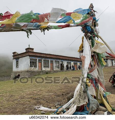 Picture - Prayer flags in front of a building, Nagarze, Shannan, Tibet, China. Fotosearch