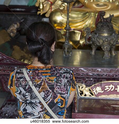 Rear view of a woman praying at the temple, Xi'an, Shaanxi, China. View Large Photo Image Stock Photography - Rear view of a woman praying at the temple, Xi'an, Shaanxi, China.. Fotosearch