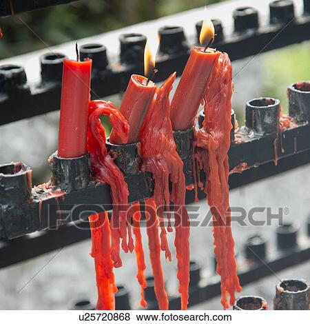 Red burning candles with melted wax at the temple, Xi'an, Shaanxi, China. View Large Photo Image Stock Photo - Red burning candles with melted wax at the temple, Xi'an, Shaanxi, China.. Fotosearch
