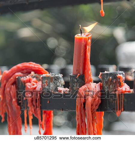 Stock Photography - Red burning candles with melted wax at the temple, Xi'an, Shaanxi, China.. Fotosearch