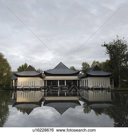 Stock Photograph - Reflection of St. Regis Hotel in water, Lhasa, Tibet, China. Fotosearch